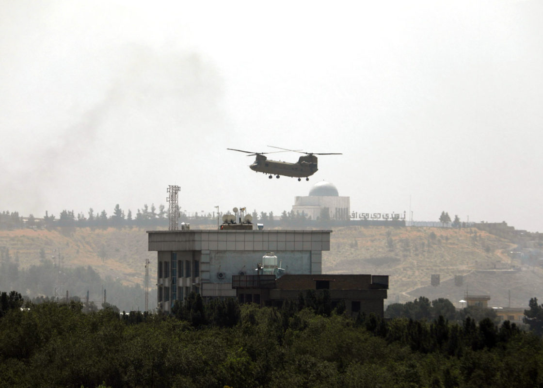 Photo By Rahmat Gul/Associated Press: A U.S. Chinook helicopter flies over the country's embassy in Kabul on Sunday as diplomatic personnel were being ferried to the airport amid the Taliban's rapid advance on the Afghan capital