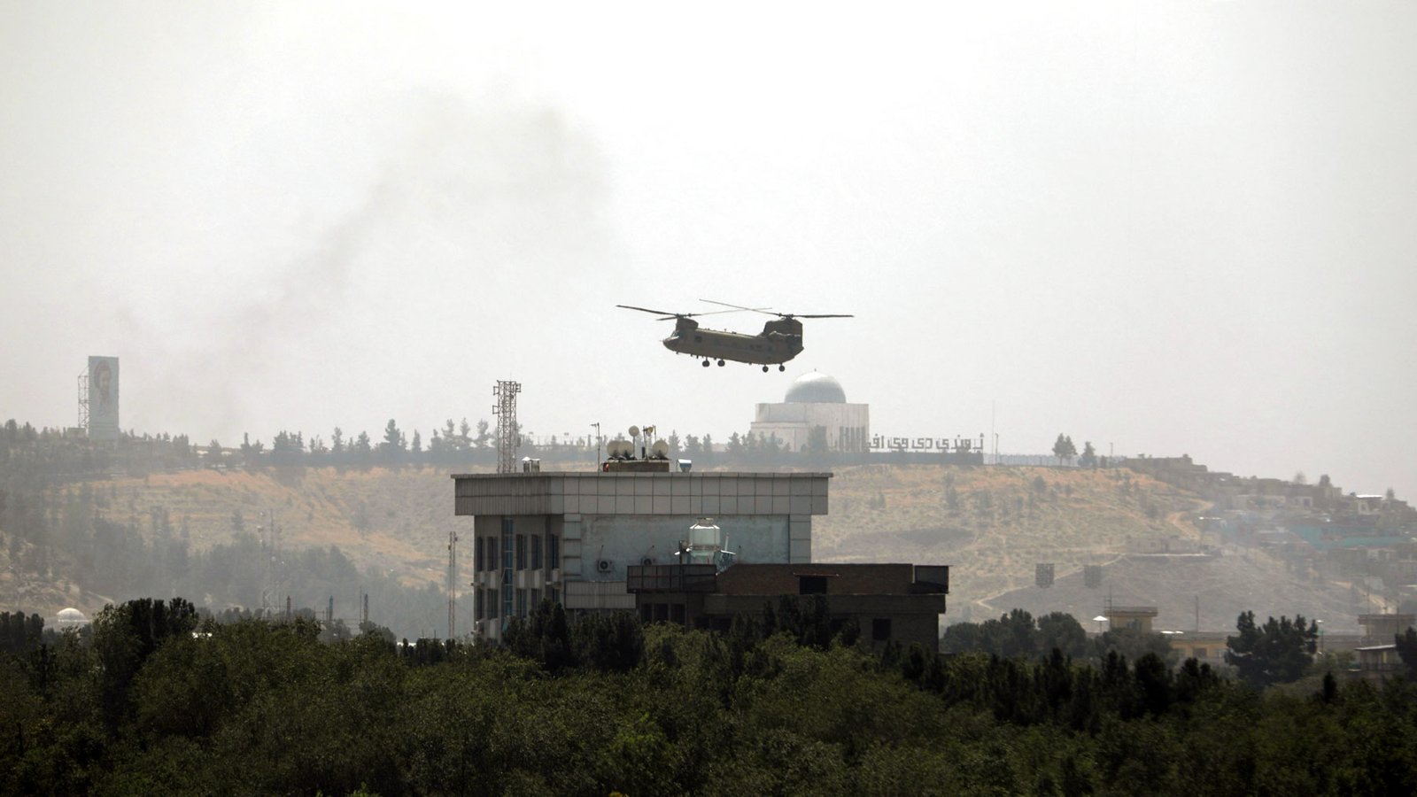 Photo By Rahmat Gul/Associated Press: A U.S. Chinook helicopter flies over the country's embassy in Kabul on Sunday as diplomatic personnel were being ferried to the airport amid the Taliban's rapid advance on the Afghan capital