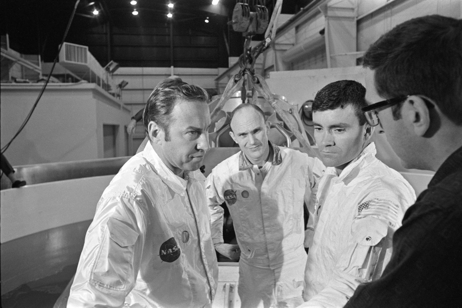The three prime crewmen of the Apollo 13 lunar landing mission stand by to participate in water egress training in a water tank in Building 260 at the Manned Spacecraft Center. They were (left to right) astronauts James A. Lovell Jr., commander; Thomas K. Mattingly II, command module pilot; and Fred W. Haise Jr., lunar module pilot. Taken January 17, 1970.